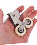 Person holding heavy duty sliding door rollers kit, 2 pack aluminum alloy wheels with stainless steel track.