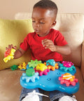 Child playing with Ocean Wonders Build And Spin Gears Toy Set, 17 Piece Preschool STEM Construction Kit For Toddlers And Kids 18 Months And Up.