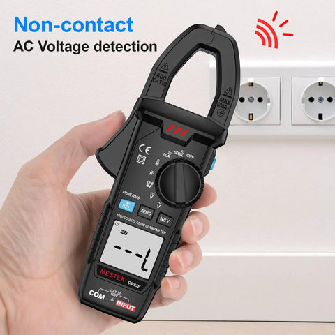 True RMS Clamp Meter Multimeter For Auto Ranging AC And DC Current And Voltage Measures, handheld in front of wall socket