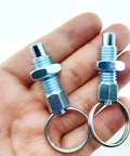 Hella Tough M10 Carbon Steel Spring Plunger With Pull Ring, two indexing pins with swivel pull rings in hand.