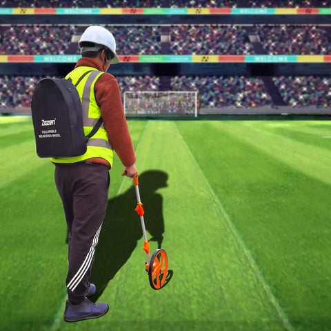 Person using Distance Measuring Wheel With Feet And Inches Readout, Collapsible Folding Design at a sports field
