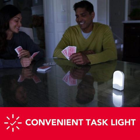 3-in-1 InstaBeam LED Power Failure Night Light illuminating a table during a card game, promoting portable task lighting.