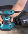 User operating 5 Inch Random Orbit Sander With Case For Smooth Rapid Sanding, Beast Mode 3.0 Amp Power Delivers 12,000 OPM, Rubberized Grip