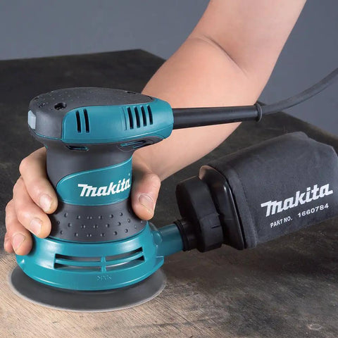 User operating 5 Inch Random Orbit Sander With Case For Smooth Rapid Sanding, Beast Mode 3.0 Amp Power Delivers 12,000 OPM, Rubberized Grip