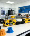 Kickass 3D Printer Filament Recycler With Auto Spool Winder And Dial In Temp Control, yellow machine on workbench, producing 1.75mm strands.