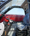 Interior view of Versatile Telescopic Handler With Quick Attach System And Enclosed Brake For Warehouses Farms Or Industrial Job Sites. Steering and seat.