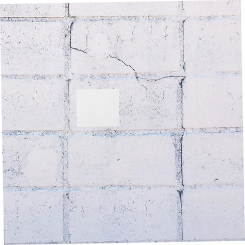 Image showing a Self Adhesive Wall Patch Kit with 12 Durable Vinyl Siding Patches fixing cracks on a concrete wall.