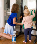 Children cleaning mirror with Streak Free Glass Cleaner Spray For Windows, Mirrors, Screens And Shower Doors, 32 oz pack of 2 on floor.