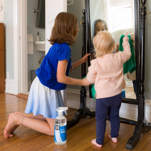 Children cleaning mirror with Streak Free Glass Cleaner Spray For Windows, Mirrors, Screens And Shower Doors, 32 oz pack of 2 on floor.