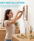 Woman using All In One 420 Piece Drywall Anchors Kit With Self Drilling Metal Plugs Holds Up To 80 Lb for picture hanging