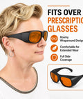 Pro Grade Multi Wavelength Laser Safety Glasses With Heavy Duty Optics Spanning 180 To 1095 Nm For Industrial Medical And Lab Work That Keep Your Vision Crisp And Bulletproof, side view on a woman with orange tint lenses.