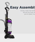 Side view of purple bagless upright vacuum cleaner with clear dust canister.
