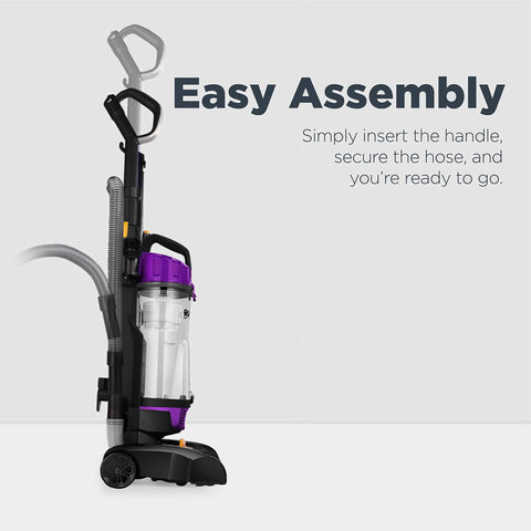Side view of purple bagless upright vacuum cleaner with clear dust canister.