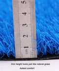 Close-up view of Durable Synthetic Grass Turf Mat For Indoor Outdoor Use With Drainage Holes showing blue 2cm fibers and ruler.
