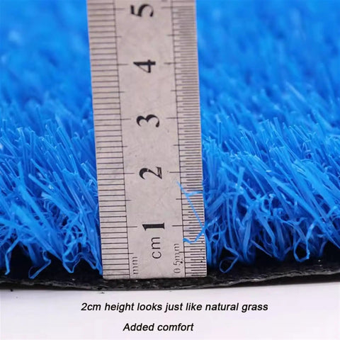 Close-up view of Durable Synthetic Grass Turf Mat For Indoor Outdoor Use With Drainage Holes showing blue 2cm fibers and ruler.