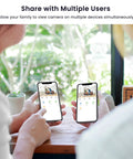 Two people viewing indoor home security camera 2K with two way audio, mobile app control on smartphones, showing live footage.