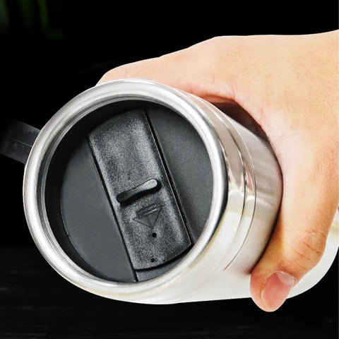 User holding the base of a Dual Voltage Car Kettle For 12V And 24V Vehicles With Insulated Stainless Steel Interior.