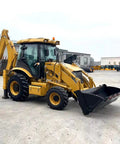 All In One Towable Hydraulic Backhoe Loader For Farm And Construction Mini Front End Loader And Excavator parked outside a building