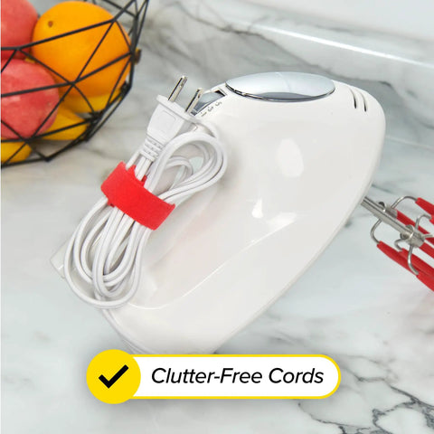 A kitchen appliance with a cord secured by a red strap from the Self-Gripping Cable Ties Set, Multi-Color 40 Pack, Reusable Hook And Loop Cable Wraps For Cord Management, Home Office Desk Organization, 5 Inch And 8 Inch Straps, Keeps Cables Neat And No More Cable Chaos.