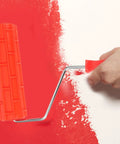 Top Shelf Rubber Textured Paint Roller With Kick Butt Spiked Surface For Walls Floors And Furniture Refinishing creating patterns on red wall.