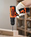 Person using Cordless 5-In-1 Drill Driver Kit With Dual Speed, Quick-Change Chuck, Two Batteries, Charger, on wooden board