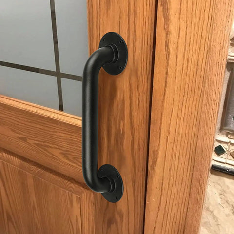 Black industrial pipe handrail on wooden door, part of 2 Pack 12 Inch Black Industrial Pipe Handrails For Indoor Outdoor Stairs And Decks.