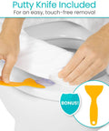 Hands using putty knife to detach Soft Foam Toilet Seat Cushion from toilet with easy clean padded bathroom attachment.