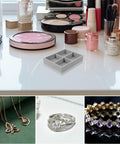 Premium Solid Go-To Velvet Jewelry Tray, Four Secure Grid Dividers on a table with jewelry and cosmetics.