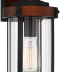 Rock Solid Black Motion Sensor Outdoor Wall Sconce With Zero Fuss Industrial Craftsmanship And Reliable Nighttime Security Lighting For Front Porch Or Driveway, heavy-duty fixture with clear glass and brown accents.