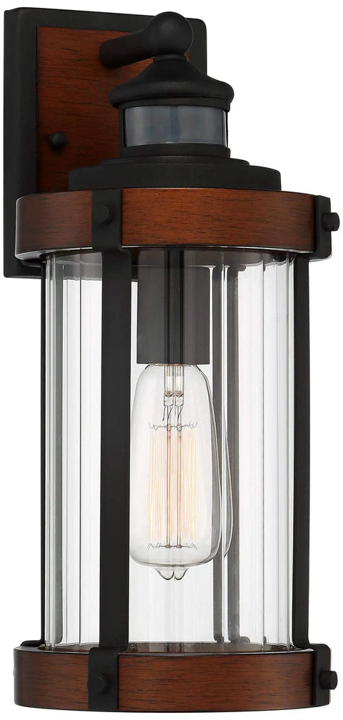 Rock Solid Black Motion Sensor Outdoor Wall Sconce With Zero Fuss Industrial Craftsmanship And Reliable Nighttime Security Lighting For Front Porch Or Driveway, heavy-duty fixture with clear glass and brown accents.