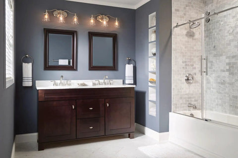 Modern bathroom with dark wood vanity, double mirrors, and elegant lighting, featuring Hamden Spot Resist Brushed Nickel 24 Inch Single Towel Bar.