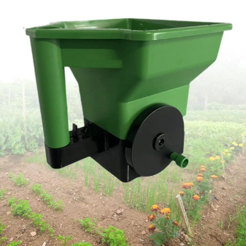 Handheld Garden Spreader For Seeds, Fertilizer And Salt Portable Manual Dispenser with Easy Grip in use over garden plot