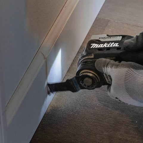 Image of 18V LXT Sub-Compact Brushless Cordless Multi-Tool With Variable Speed Control 10,000 to 20,000 OPM in use against baseboard.