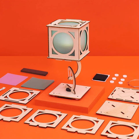 Levitating Lantern STEM Kit For Kids 9 Plus with wooden tensegrity base and building components on orange background
