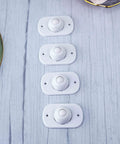 4 Pcs Self Adhesive 360 Degree Swivel Caster Wheels in white nylon, lined up on a wooden surface, ideal for under bed use.