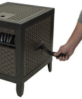 Person using NeverLeak Hose Reel Cabinet With 100 Ft Capacity, Decorative Wicker Look, Auto Track Rewind, Black Metal Outdoor Hose Storage Box for Yard, Patio Or Deck Keeps Hoses Looking Slick And Stylish with handle
