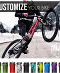 Cyclist performing wheelie with Dual Color Lock On MTB Grips For Mountain Bike BMX And E Bike Non Slip Shock Absorbing Grips