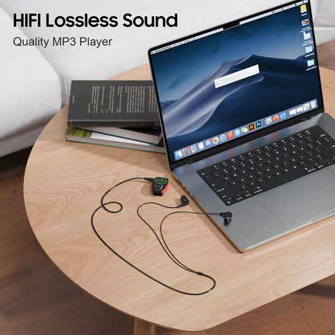 Clip-On MP3 Player With LED Light, 8GB Mini Music Player on table next to laptop for Sports, Gym, running and jogging