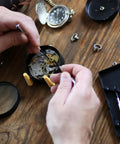 Hands repairing watch mechanism using tools from Watch Screws Kit 100 Pieces Micro Screw Assortment for Battery Clamp Replacement and Quick Watch Repair Gear Fits Most Watches Replacing Lost Screws and Fastening Back Covers for Diyers