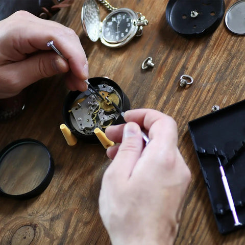 Hands repairing watch mechanism using tools from Watch Screws Kit 100 Pieces Micro Screw Assortment for Battery Clamp Replacement and Quick Watch Repair Gear Fits Most Watches Replacing Lost Screws and Fastening Back Covers for Diyers