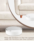 Solid Wood Bed Risers Set Of Four with a robotic sweeper under a couch, showing elevated furniture for easy cleaning.