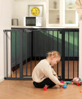 Metal Baby Gate For Doorways And Stairs Extra Wide Fits 29 To 48 Inches Auto Close Walk Through barrier with child playing nearby