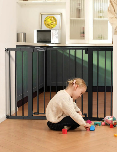 Child playing by Extra Wide 29 To 55 Inch Baby And Dog Gate For Stairs And Doorways, auto close, pressure mounted, gray steel gate