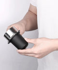 Person holding 53.3mm Portafilter Dosing Cup In 304 Stainless Steel With Matte Black Nonstick Finish for 54mm Breville Machines
