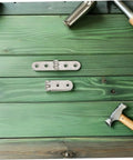 Heavy Duty Folding Table Hinges Set 12 Piece Nickel Plated 76x15x2mm on green wooden table with tools
