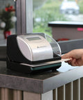 Electronic Time Clock Machine With Automatic Daylight Savings And Battery Backup, Hassle-Free Employee Punch Tracker For Small Business on countertop.
