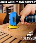 Compact Cordless Palm Sander With 16.8V Battery And 3 Inch Pad for easy wood sanding shown in hand on wood surface.
