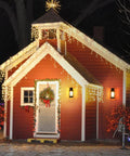 Red house with Christmas lights and wreath, featuring Dope Outdoor Wall Light Fixture With Clear Glass Shade on the porch.