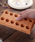 Wood Pliers Block Organizer for the Bench Fits 6 Pairs in a 12 Hole Pliers Rack held in hand on a wooden table