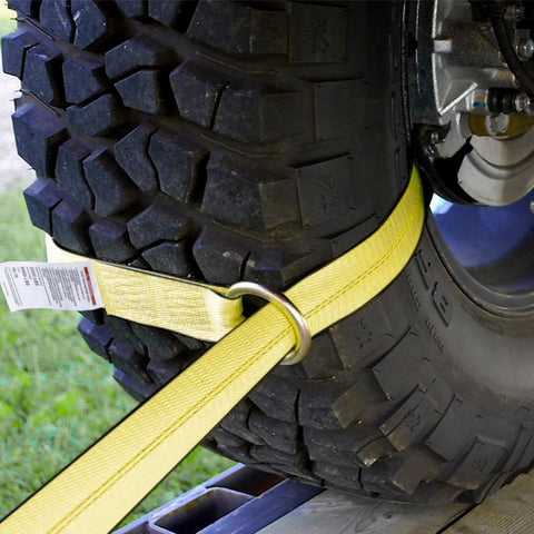 Close-up of vehicle tire secured with Four Pack 2 Inch By 96 Inch Tie Down Straps Kit With J Hook Ratchets And Wear Pads For Cars SUVs Jeeps